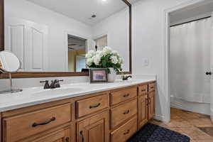 Full bathroom with vanity, toilet, and shower / bath combo with shower curtain