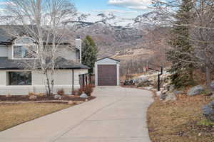 View of side of home with a mountain view