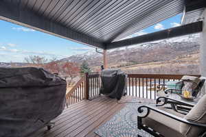 Deck featuring a mountain view and a grill