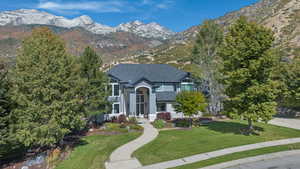 View of front facade featuring a front lawn and a mountain view