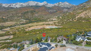 Aerial overview of property's location featuring mountains and nearby suburban area