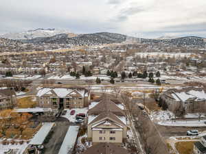 Snowy aerial view featuring a mountain view