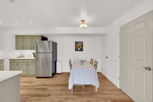 Dining area with light hardwood / wood-style flooring