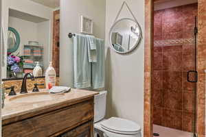 Bathroom with vanity, toilet, and walk in shower