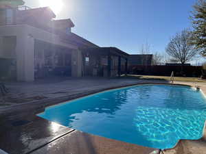 View of swimming pool with a patio area