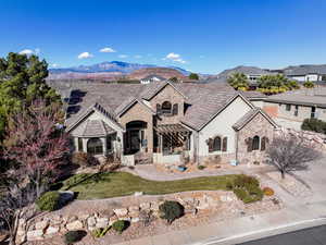 View of front of property featuring a mountain view and a front yard