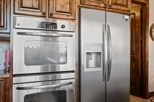 Kitchen featuring appliances with stainless steel finishes and wood-type flooring