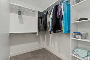 Walk in closet with carpet floors