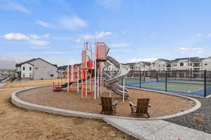 View of jungle gym with tennis court