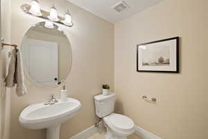 Bathroom with tile patterned flooring, sink, and toilet