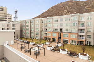 View of building exterior with a mountain view and a fire pit