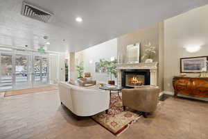 Living room featuring a fireplace, light hardwood / wood-style floors, and a textured ceiling