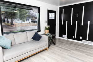 Living room with plenty of natural light and hardwood / wood-style floors