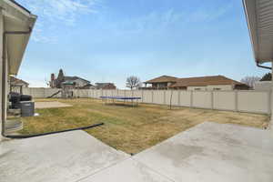 View of yard featuring a playground, a patio, and a trampoline