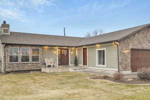 Ranch-style home with a garage and a front lawn