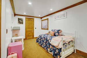 Carpeted bedroom with crown molding