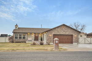 View of front facade featuring a garage and a front yard