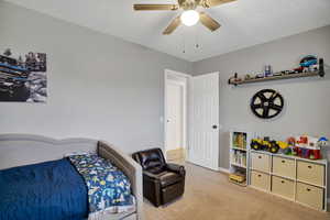 Carpeted bedroom with ceiling fan