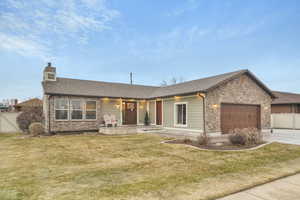 Ranch-style house with a garage and a front yard