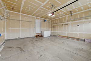 Garage with refrigerator and a garage door opener