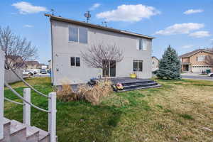 Back of property featuring stucco siding and a lawn