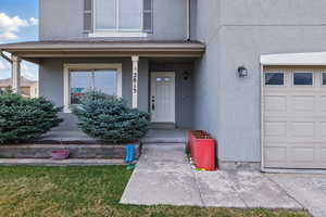 Doorway to property with stucco siding and a porch