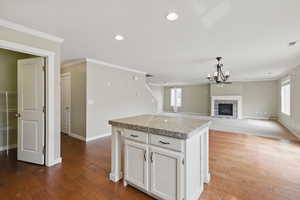 Kitchen with visible vents, an inviting chandelier, crown molding, and hardwood / wood-style flooring