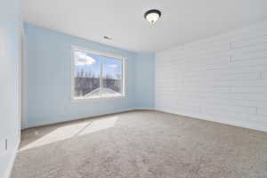 Unfurnished room with baseboards, visible vents, and carpet flooring