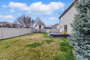 View of yard with a fenced backyard and a wooden deck
