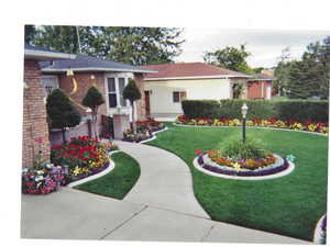 View of front facade with brick siding and a front yard