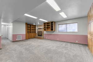 Downstairs family room with fridge, sink and dishwasher