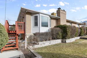 View of side of home featuring a lawn