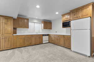 Downstairs family room with fridge, sink and dishwasher