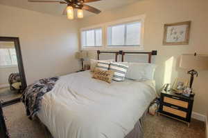 Carpeted bedroom with ceiling fan