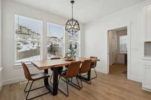 Dining space featuring light hardwood / wood-style flooring and a chandelier