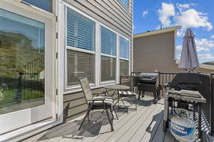 Wooden deck featuring area for grilling