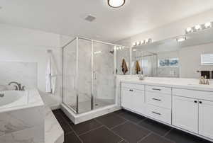 Bathroom with vanity and independent shower and bath