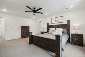 Carpeted bedroom with ceiling fan