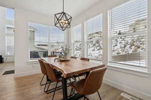 Dining area with an inviting chandelier and light wood-type flooring