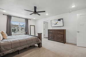 Bedroom featuring ceiling fan and light carpet