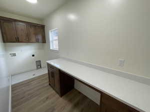 Laundry room with cabinets, washer hookup, light hardwood / wood-style flooring, and electric dryer hookup