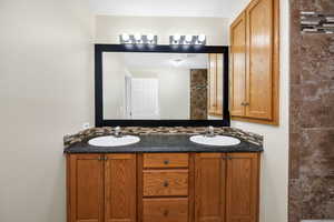 Bathroom featuring tasteful backsplash and vanity