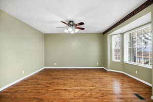 Spare room with ceiling fan and wood-type flooring