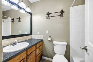 Full bathroom featuring vanity, shower / bathing tub combination, decorative backsplash, and toilet