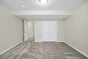 Unfurnished bedroom with carpet floors, a closet, and a textured ceiling