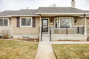 View of front of house with a front lawn and a porch