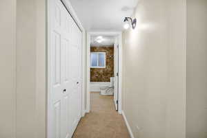 Corridor featuring light tile patterned flooring