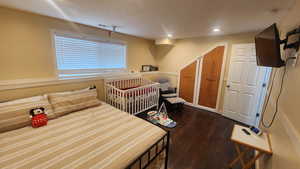 Master Bedroom downstairs featuring dark hardwood / wood-style flooring