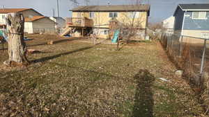 View of yard featuring a playground and a deck