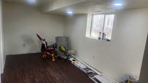 Family room downstairs featuring dark wood-type flooring and a textured ceiling